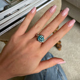 Art Deco zircon and diamond engagement ring, worn on hand.