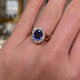 Victorian, sapphire and diamond cluster engagement ring, worn on hand and rotated to give perspective.
