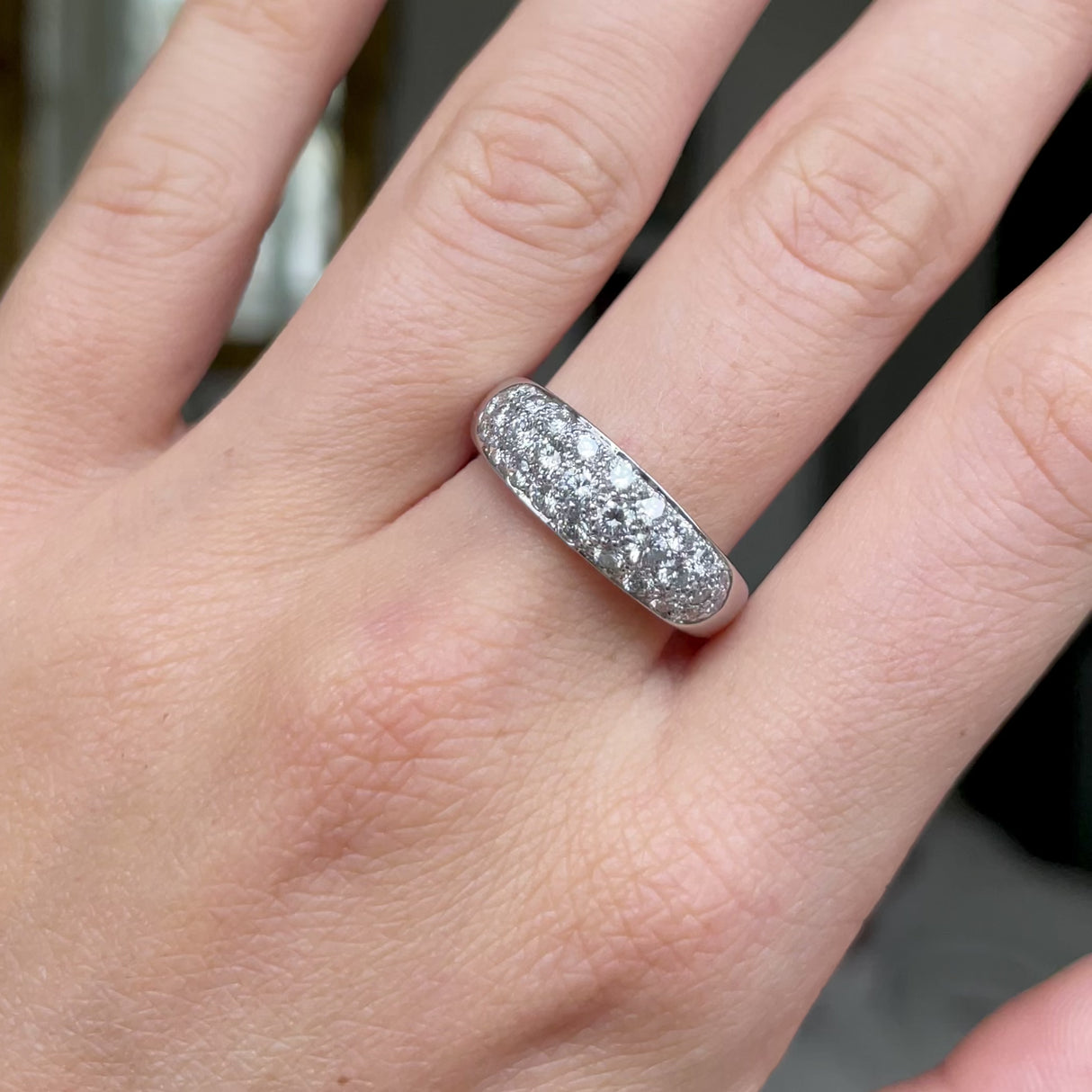Diamond set platinum band worn on hand and moved around to give perspective.