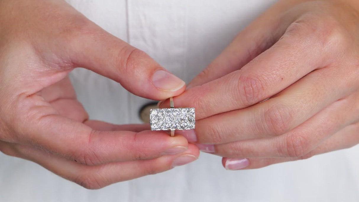 Art Deco diamond panel ring, held in fingers and rotated to give perspective.