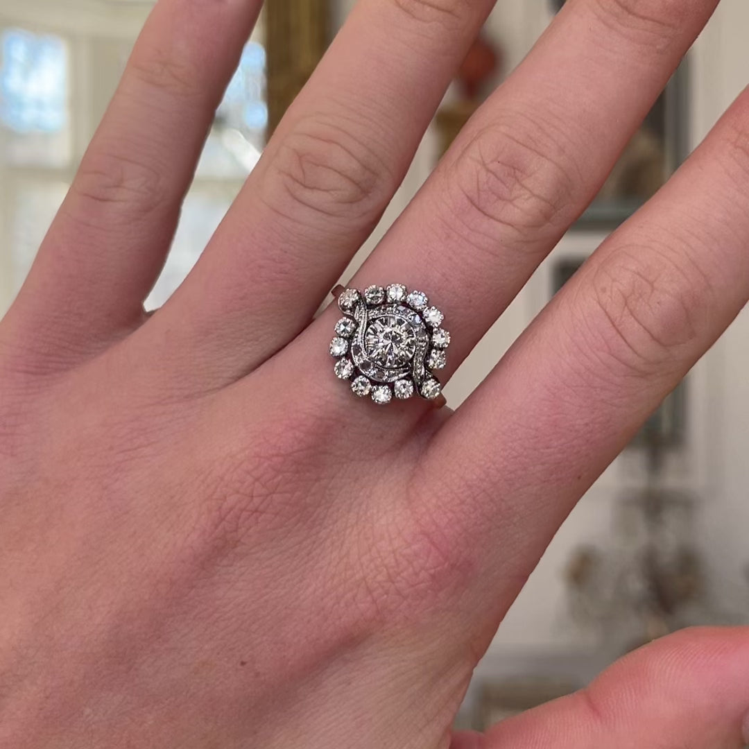 Antique French diamond cluster engagement ring, worn on hand and rotated to give perspective.