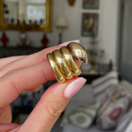 Victorian yellow gold snake ring, held in fingers and rotated to give perspective.